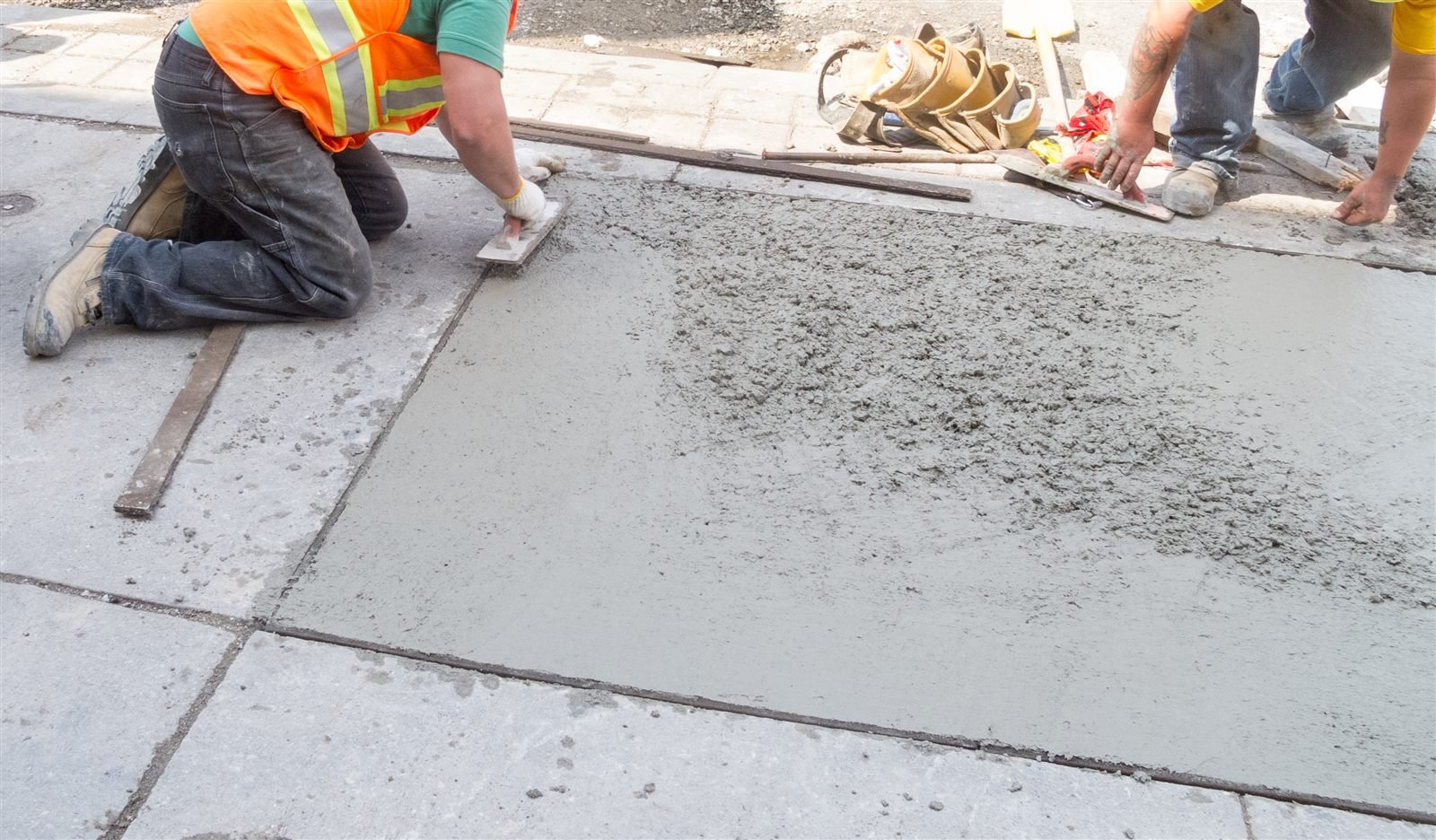 Crew replacing a damaged concrete sidewalk section in Omaha, NE