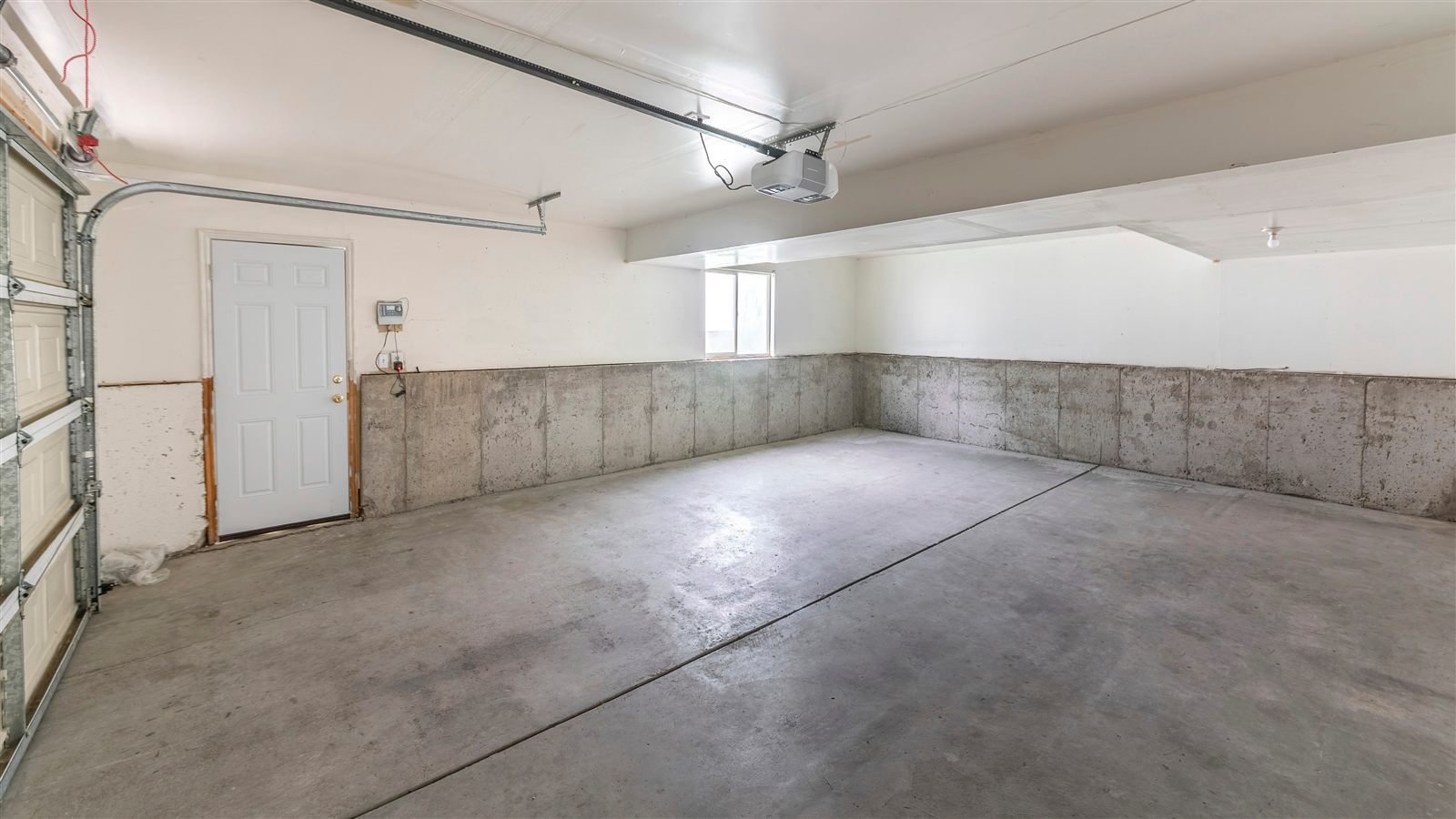 Worn concrete garage floor and foundation walls in an Omaha, NE home