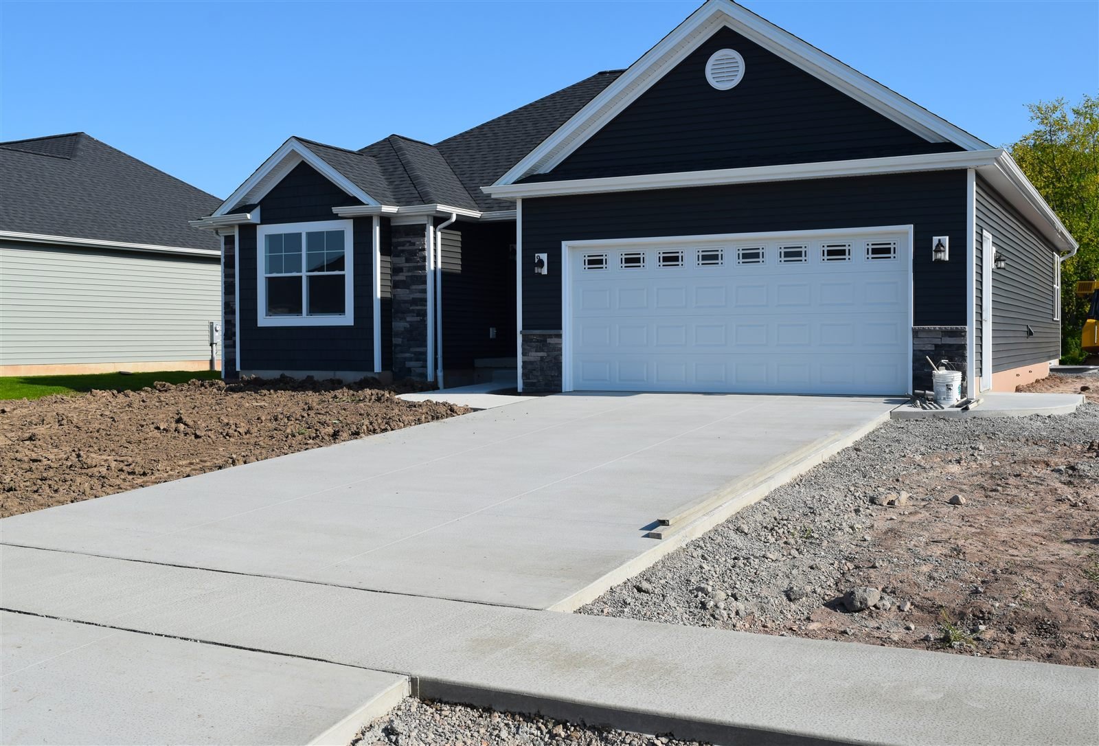 Newly finished concrete driveway and sidewalk at a new home in Omaha, NE
